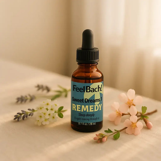 Amber flower remedy bottle labeled Feel Bach on linen bedside with wildflowers in warm morning sunlight